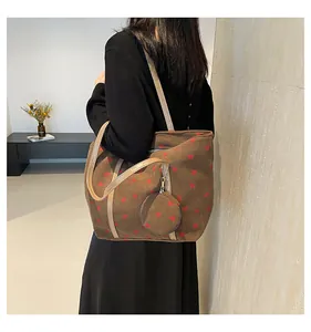 Detail of a brown corduroy tote bag with heart patterns and a round coin purse