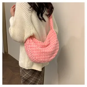 Pink checkered plush shoulder bag shown on model with soft faux fur texture for winter