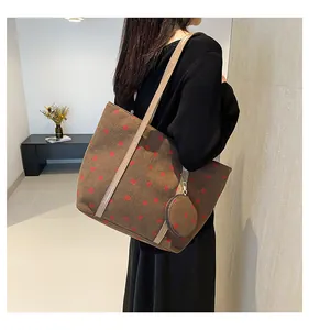 Detail of brown corduroy tote bag with strawberry print and small matching coin purse