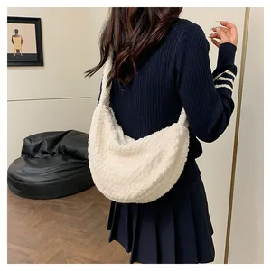 Close-up of the plush faux fur texture and crescent shape on this white puffer cloud bag