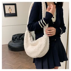 Close-up of soft off-white sherpa hobo bag showing fuzzy texture and wide strap