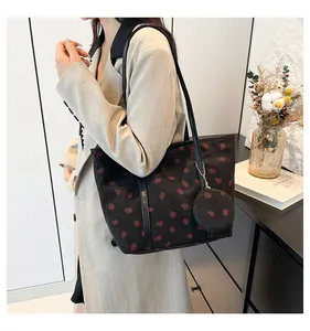 Detail view of strawberry pattern corduroy tote bag with small round coin purse