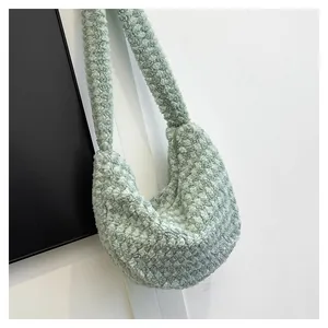 Detail of light green pleated hobo bag in soft faux shearling with zip closure