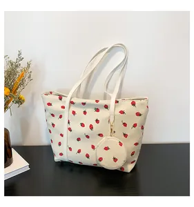 Detail of cream corduroy tote bag with red strawberry print and matching coin purse