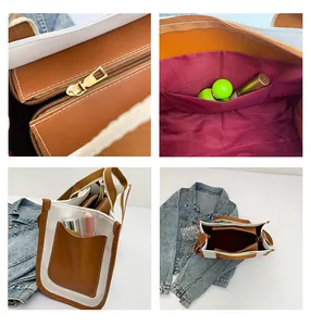 Detail view of canvas tote showing gold zipper, red lining, and leather side pocket