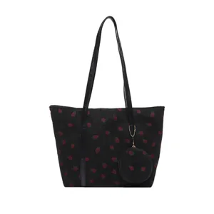 Large black corduroy tote bag with red strawberry print and small matching round purse