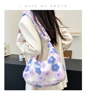 Detail of soft white plush tote bag featuring colorful fuzzy flower patterns and shoulder strap