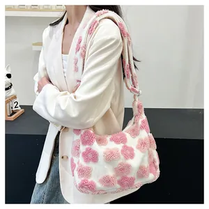 Detail of soft plush tote bag featuring pink floral 3D patterns and fuzzy wide strap