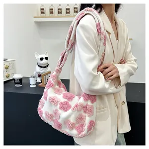 Detail of soft white plush tote bag featuring pink fuzzy flower patterns and shoulder strap