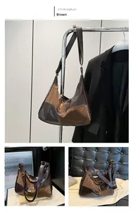 Detail view of contrast stitching and vintage PU leather texture on the brown tote bag