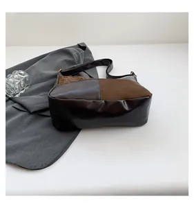 Close-up of contrast color tote bag with polished dark brown leather and matte textures