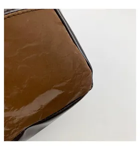 Detailed close-up of premium contrast color tote bag with glossy pleated finish and fine stitching