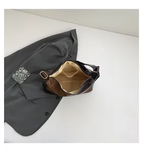 Interior view of brown leather tote showing spacious lining and dual storage pockets