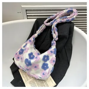 Close-up of floral plush tote bag featuring soft faux fur texture and adjustable metal buckle