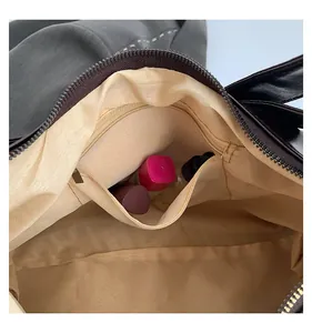 Detailed interior view of contrast tote bag showing zipper pockets and fabric lining