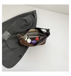 Detail shot showing the spacious interior of a brown leather tote with daily essentials