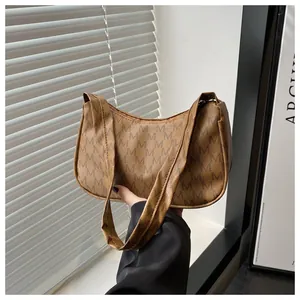 Detailed view of vintage crescent shoulder bag with brown monogram pattern and wide handle