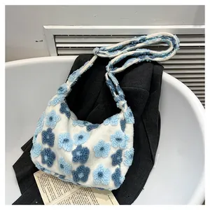 Detailed close-up of floral plush shoulder bag showing soft faux fur texture and patterns