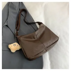 Dark brown faux leather shoulder bag with cute plush smiley star charm detail