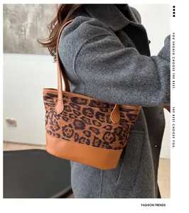 Detailed view of the leopard print and brown leather stitching on a fashion shoulder bag