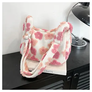 Macro view showing 3D floral embroidery on soft plush tote bag with cozy fleece texture
