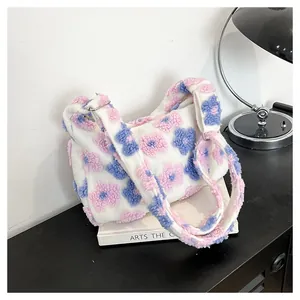 Detailed view of plush floral tote bag texture with pink and blue flower embroidery