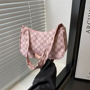 Retro crescent underarm bag in pink with grey M-letter prints and adjustable shoulder strap