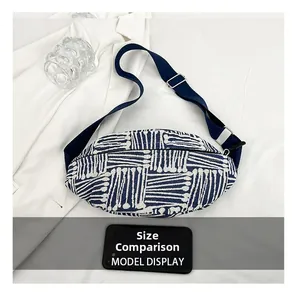 Size comparison of ethnic canvas crossbody bag with a smartphone on white background