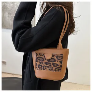 Side view of a vintage leopard print tote bag on a model showing size and texture