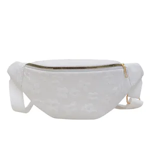 White chest bag with floral textured fabric and adjustable strap in semi-circle shape