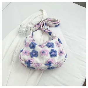 Close-up of floral plush tote bag with soft 3D flower patches and metal buckle strap