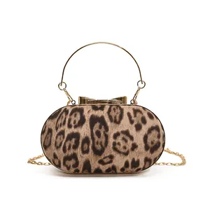 Fashionable leopard print oval evening bag with gold ring handle and metal chain