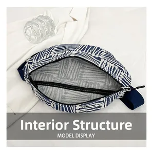 Internal structure of blue and white geometric canvas waist bag with black zipper