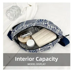 Internal capacity of the canvas waist bag showing storage for a wallet and cosmetics