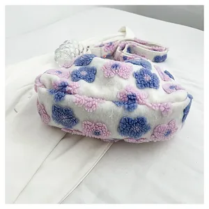 Close-up of plush tote bag with colorful 3D flower patterns and adjustable strap