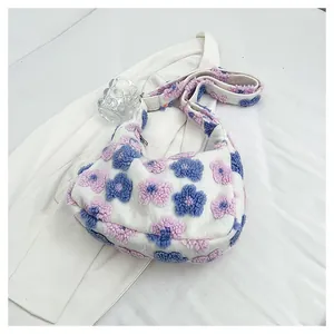 Detailed close-up of floral plush hobo bag with purple and blue 3D flower patterns