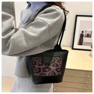 Detail of vintage tote bag with dark leopard print panel showing on-shoulder fit