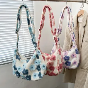 Floral plush tote bags in blue, pink, and purple with fuzzy flowers and wide straps