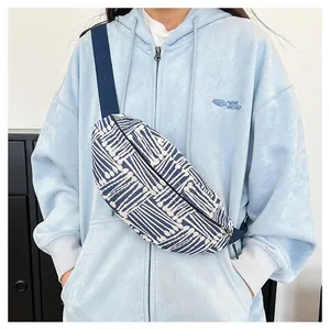Close-up of blue and white striped canvas chest bag with adjustable strap on model