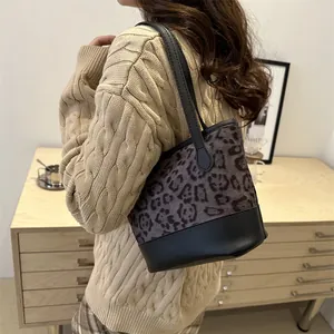 Fashionable leopard print bucket bag for women with black leather straps and retro style