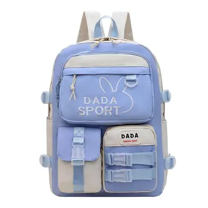 Detail of light blue and beige school backpack with rabbit ears and DADA SPORT embroidery