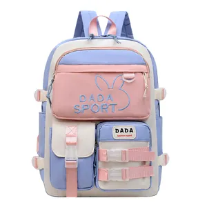 Front detail of pink and blue school backpack featuring DADA SPORT embroidery and pockets