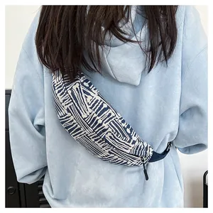 Detail of canvas crescent chest bag featuring ethnic blue and white geometric patterns
