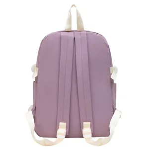 Detail view of the padded shoulder straps and purple nylon fabric of the school backpack