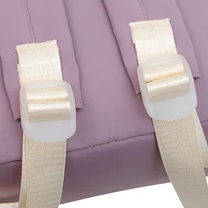 Detail of adjustable purple nylon shoulder strap with cream webbing and plastic buckle