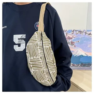 Detailed shot of ethnic striped canvas chest bag with woven pattern and wide shoulder strap