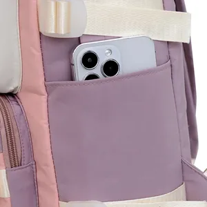 Detail of pink and purple backpack side pocket showing water-resistant nylon texture