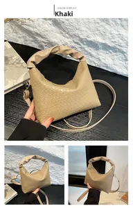 Detail of khaki shoulder bag with woven texture and ruched handle craftsmanship