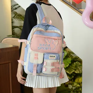 Detail of color-block backpack showing pink straps and DADA SPORT embroidery
