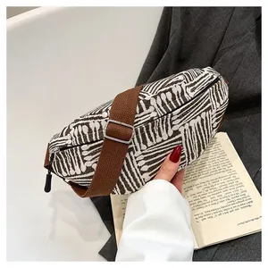 Detail of bohemian canvas chest bag with adjustable strap and striped weave texture